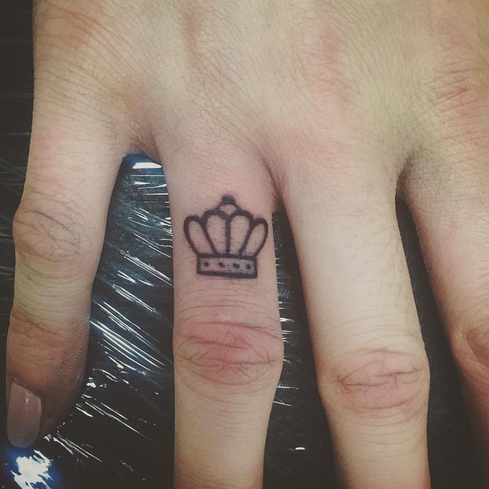 Crown finger tattoos.