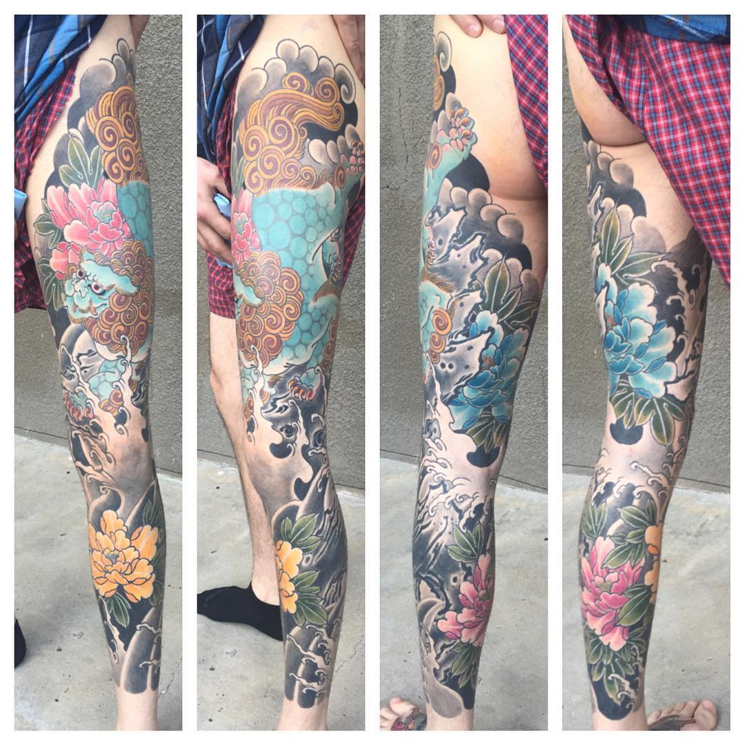 Watercolor leg and sleeve tattoo.