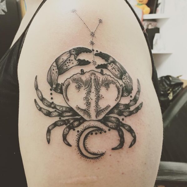 Fashionable cancer zodiac tattoo.